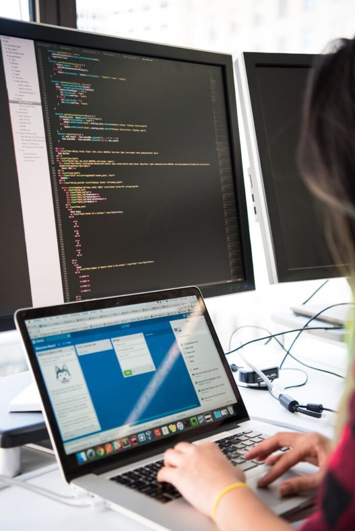 person using both computer and a laptop