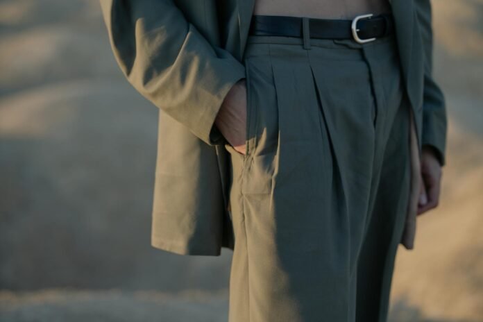 person in blue dress shirt and black pants