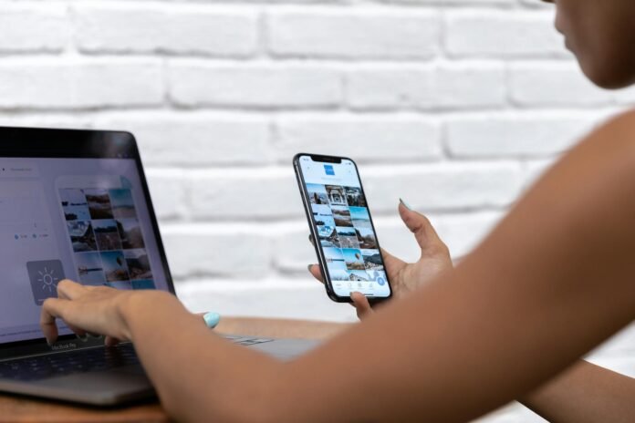 person using laptop and smartphone