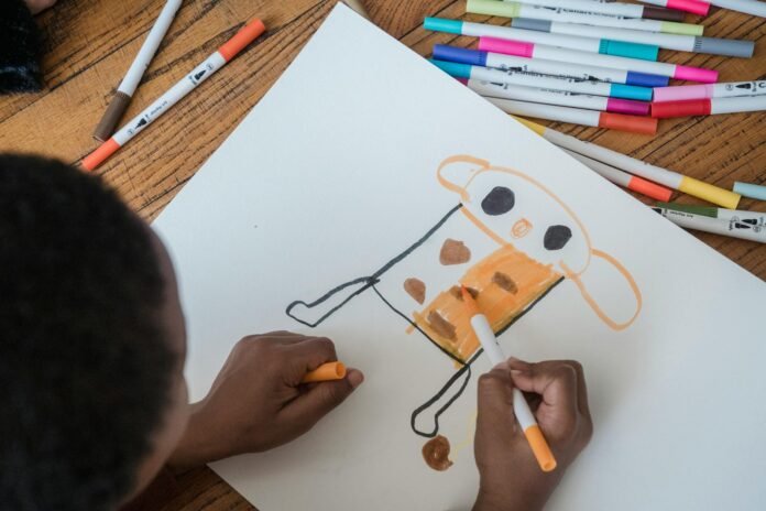 a child coloring using colored pens