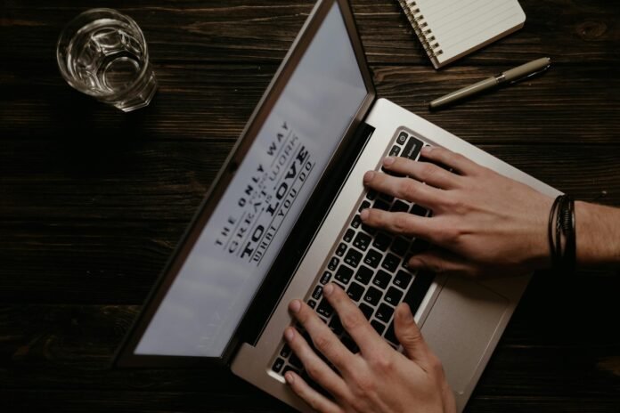 top view of typing on a laptop