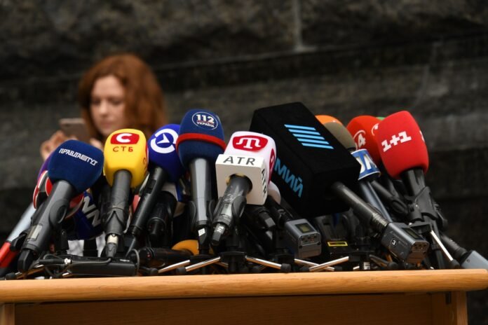 microphones on desk at press conference