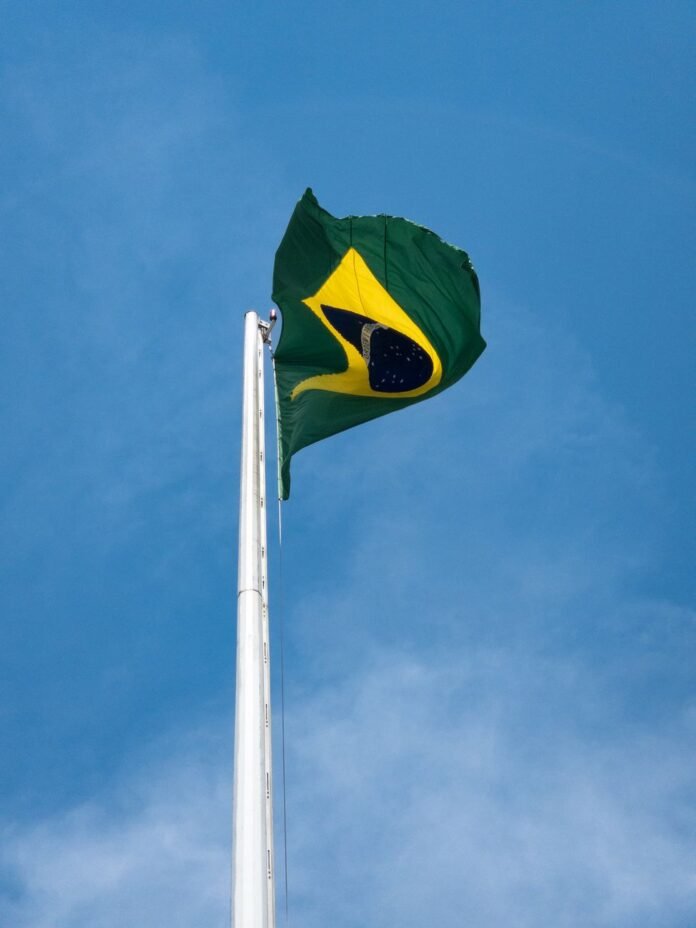 brazilian flag waving against blue sky