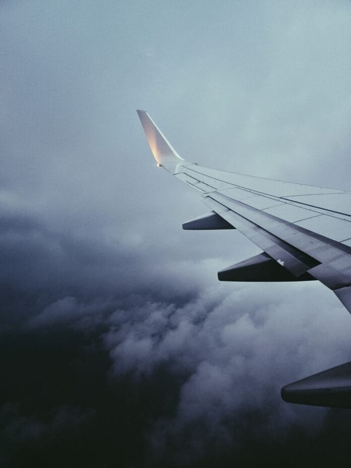 airplane wing in stormy cloudy skies